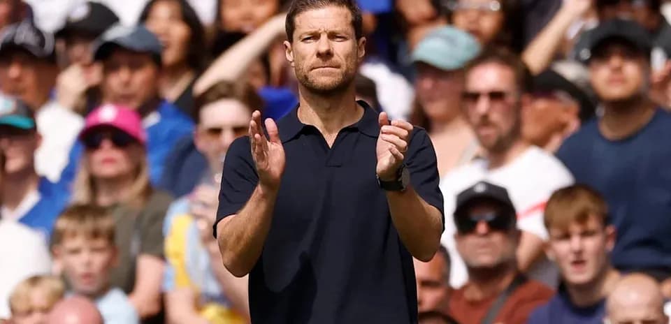 Coach clapping in front of cheering crowd
