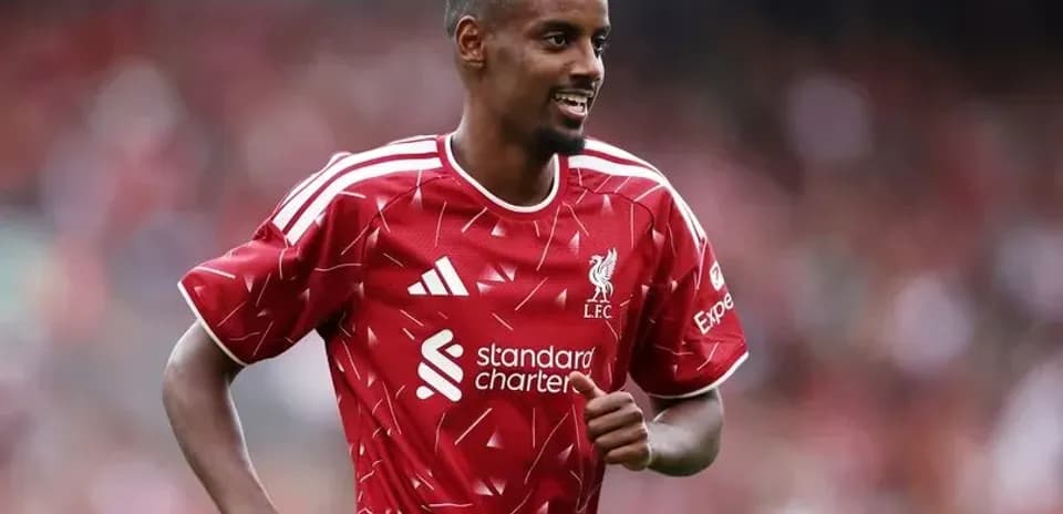 Player celebrating during match wearing Liverpool kit
