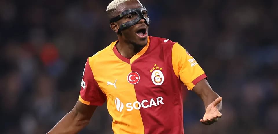 Player celebrating wearing a protective mask during match