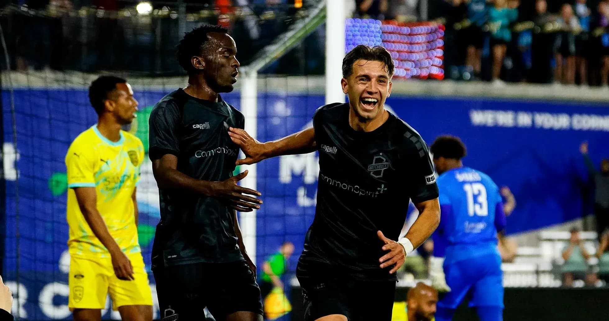 Players celebrating a goal during FC Tulsa match