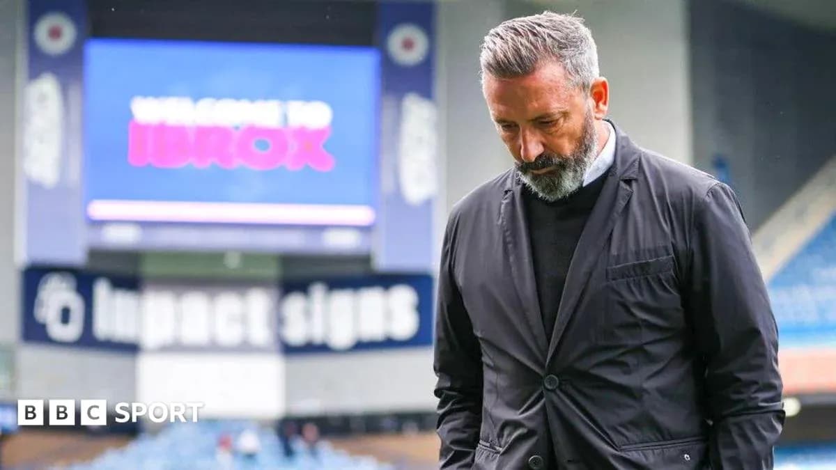 Manager walking with head down at Ibrox Stadium