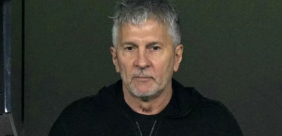 Man with gray hair in black jacket
