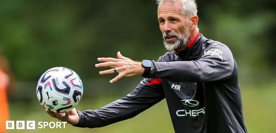 Coach demonstrating a drill while holding a ball