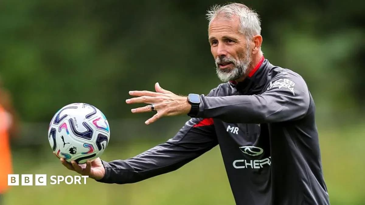 Coach demonstrating a drill while holding a ball