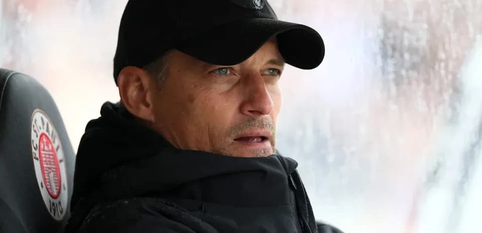 Coach observing from the sidelines in rainy weather