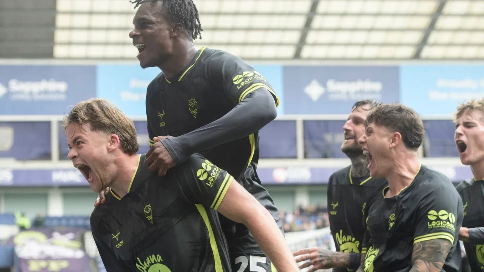 Players celebrating a goal during football match