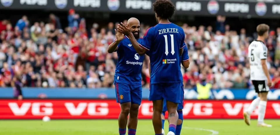 Two players celebrating on the field during match