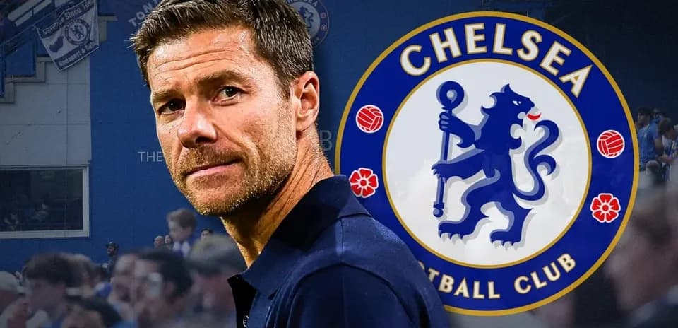 Coach in front of Chelsea FC logo at stadium