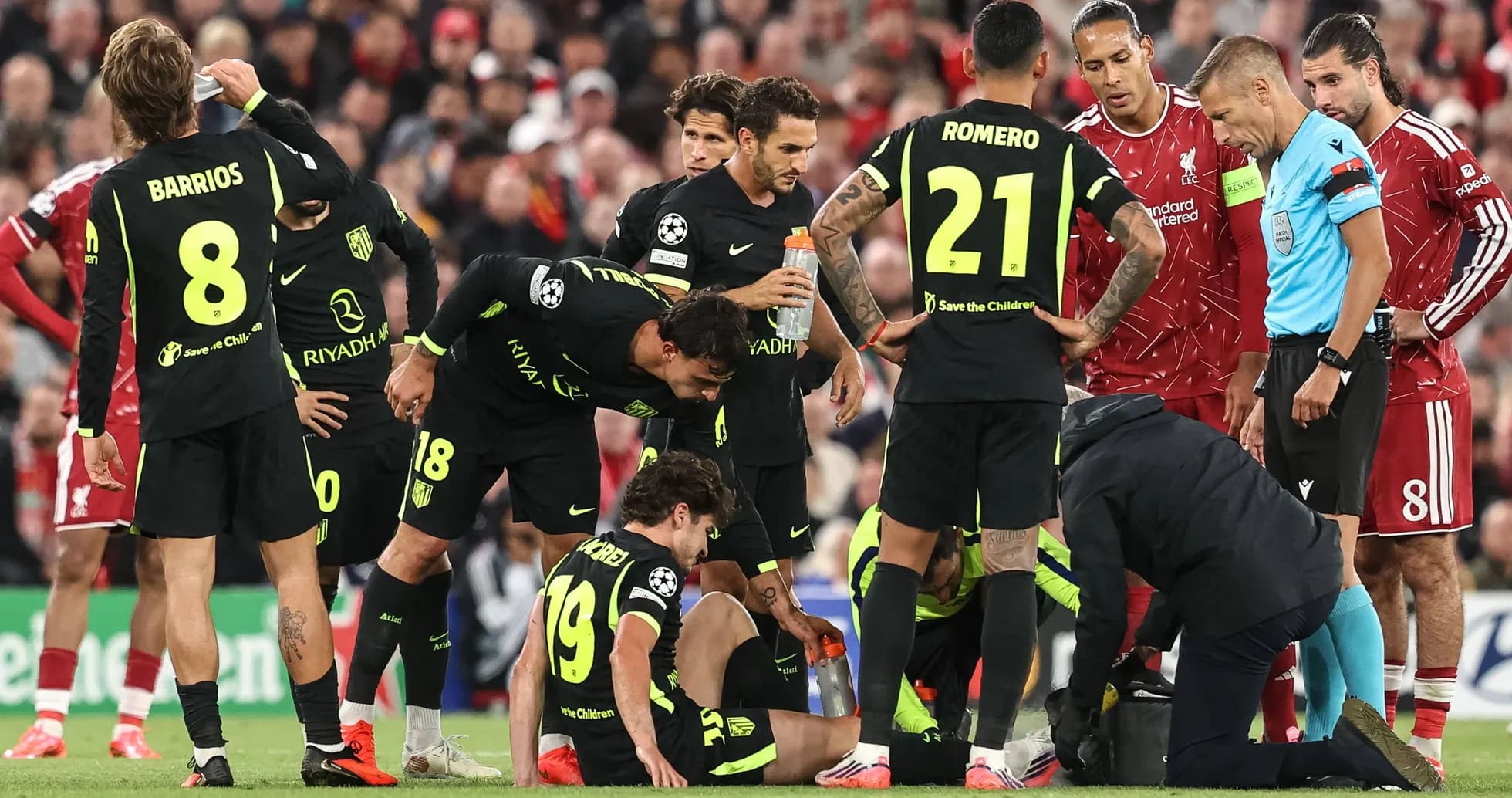 Atletico Madrid players gather around injured teammate