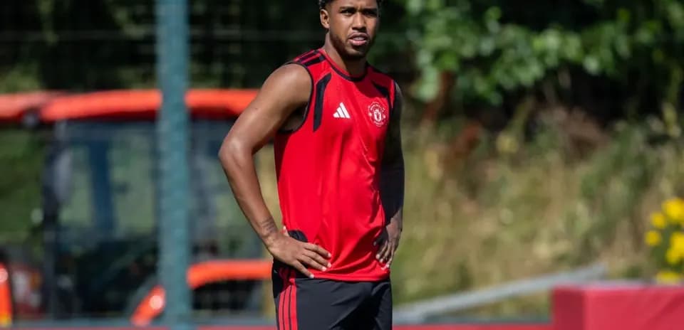 Player in Manchester United training kit on pitch