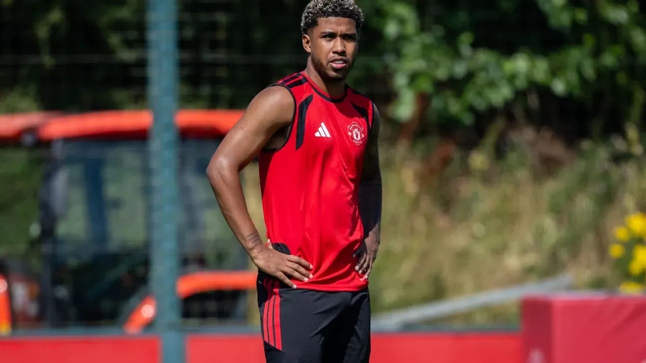 Player in Manchester United training kit on pitch