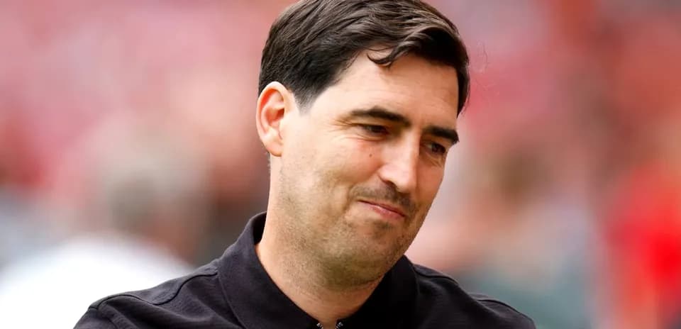 Man in black polo shirt at sporting event