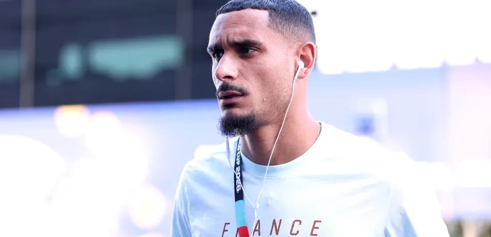 Player wearing headphones, arriving at venue