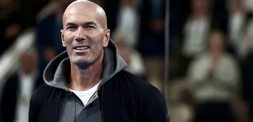 Man smiling while standing in a crowd