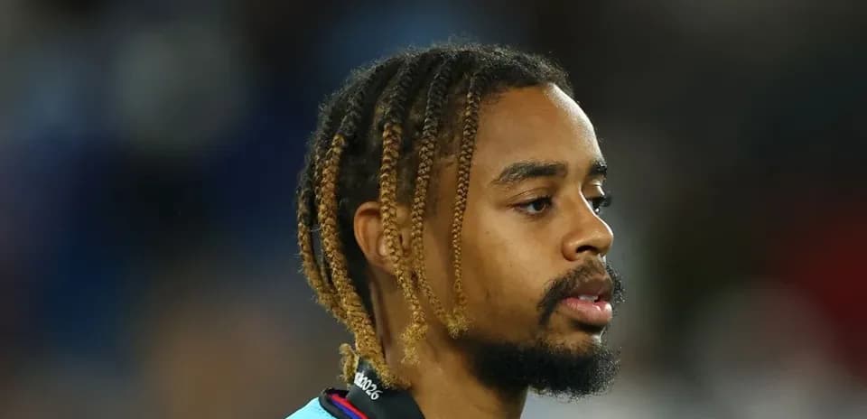 Player with braided hair wearing a sports jersey