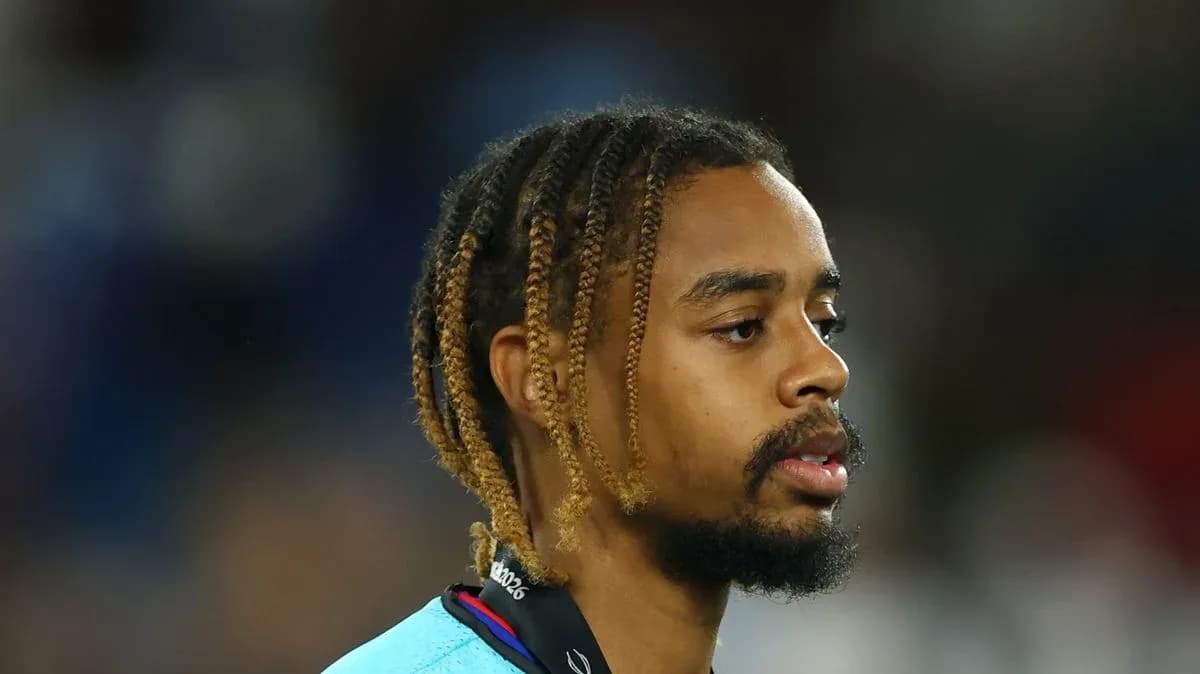 Player with braided hair wearing a sports jersey