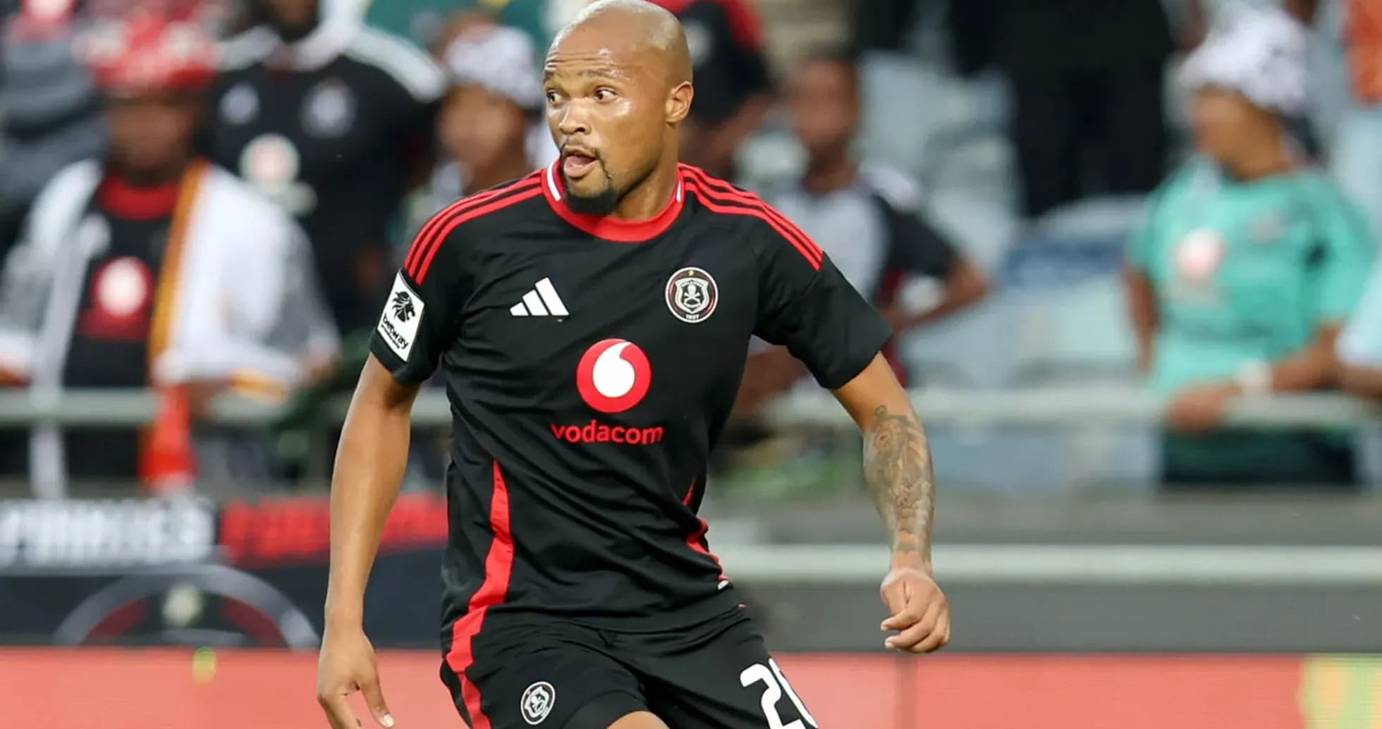 Player in black jersey running on the field