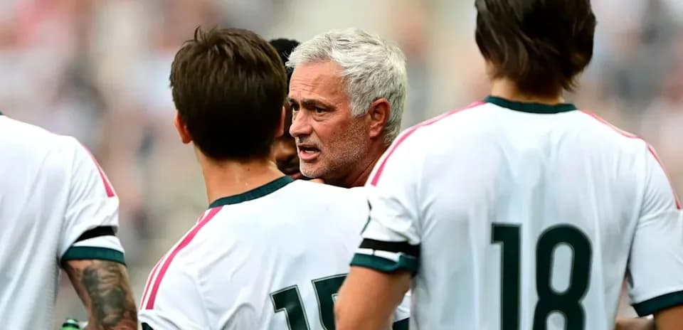 Manager discussing strategy with players during match