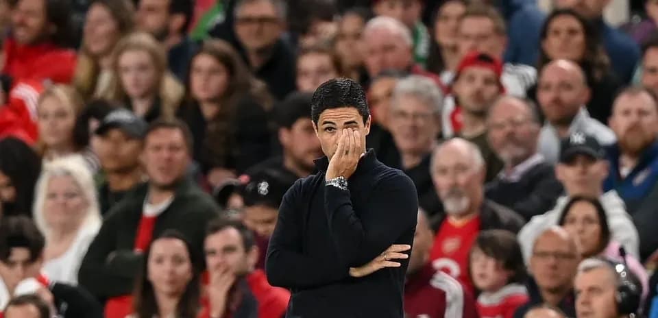 Manager observing match with fans in background