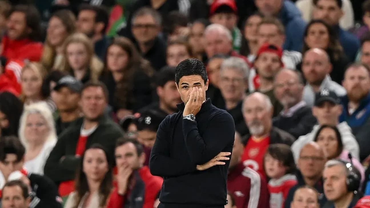 Manager observing match with fans in background