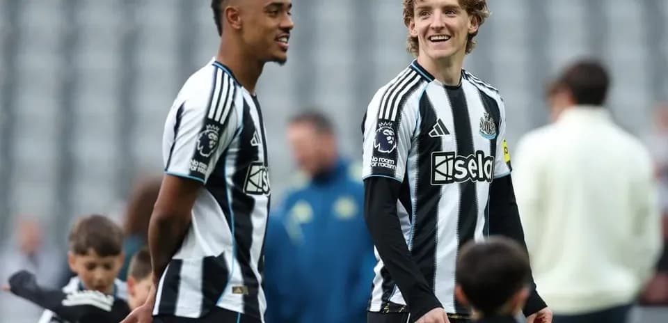 Two Newcastle players smiling during training session