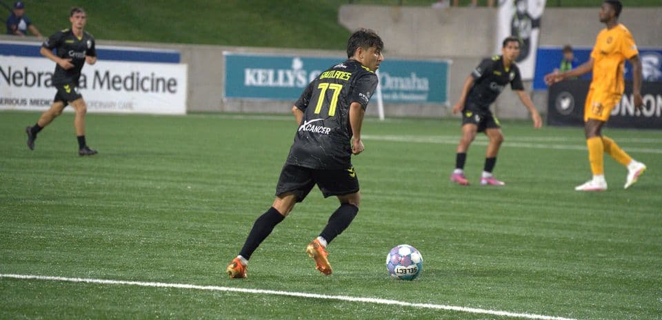 Player dribbling the ball during Union Omaha match