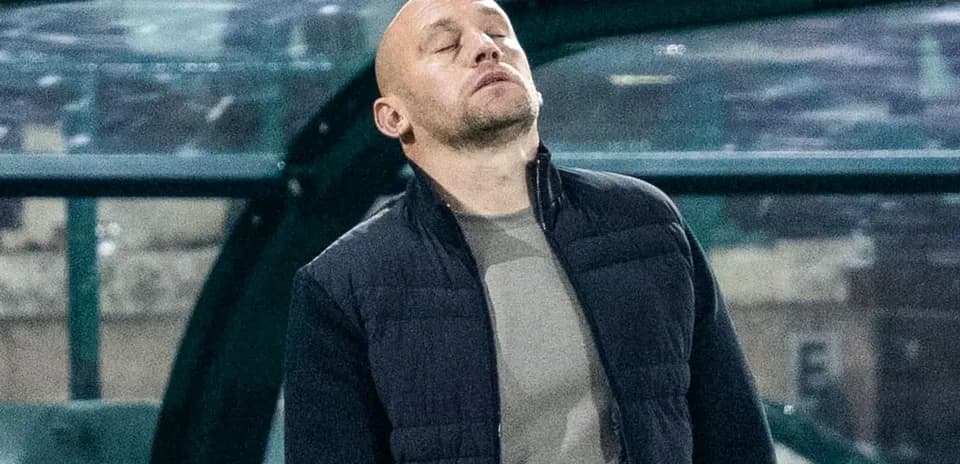 Coach with eyes closed on the sidelines