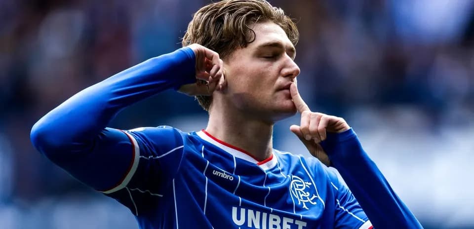Player celebrating with a shushing gesture after scoring