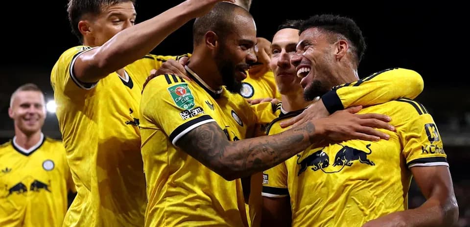 Players celebrating a goal during a match