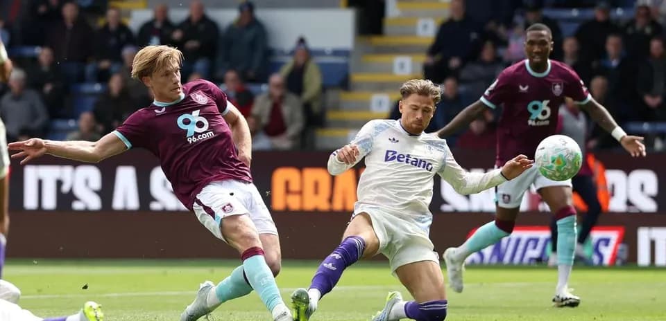 Burnley player tackling Aston Villa opponent