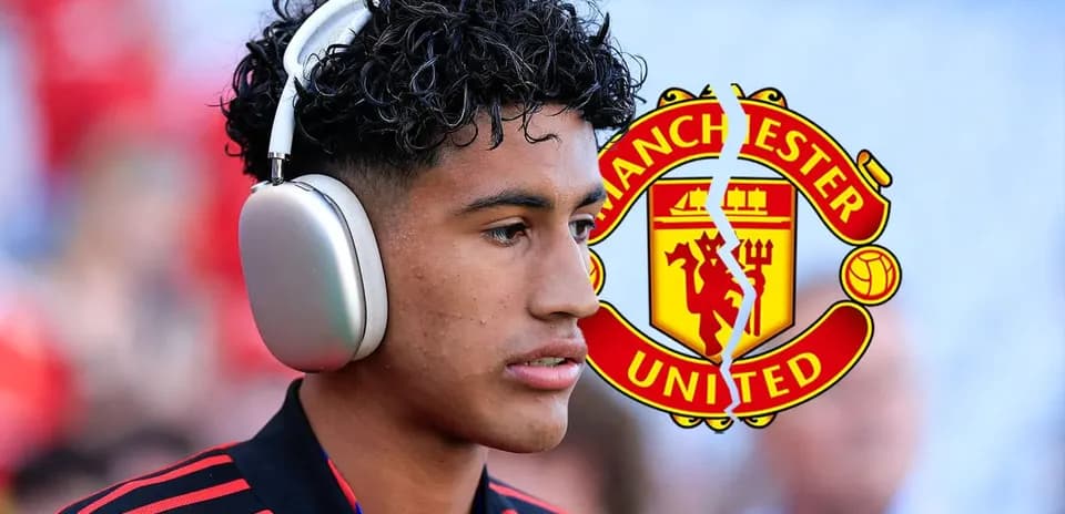 Player wearing headphones before match with Manchester United logo
