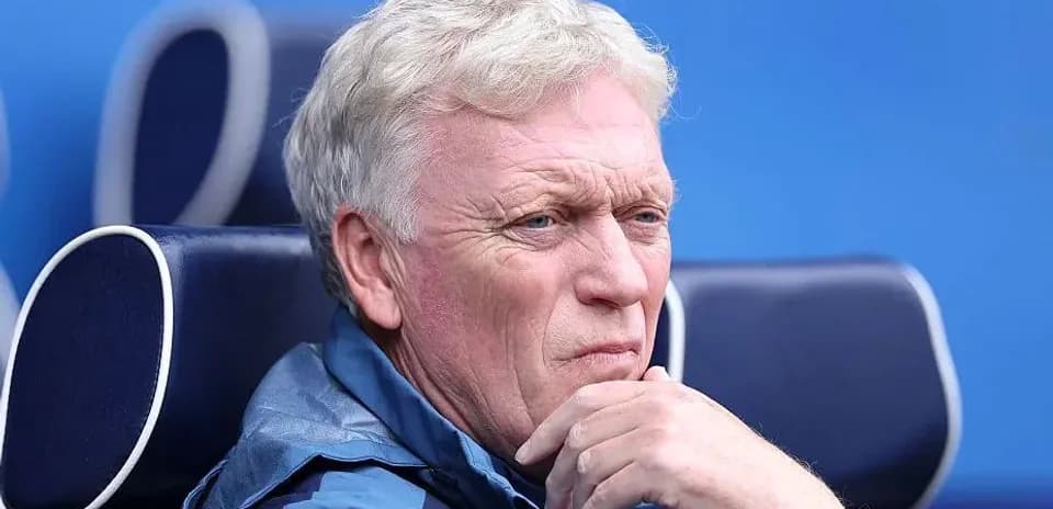 Coach sitting on bench during a match