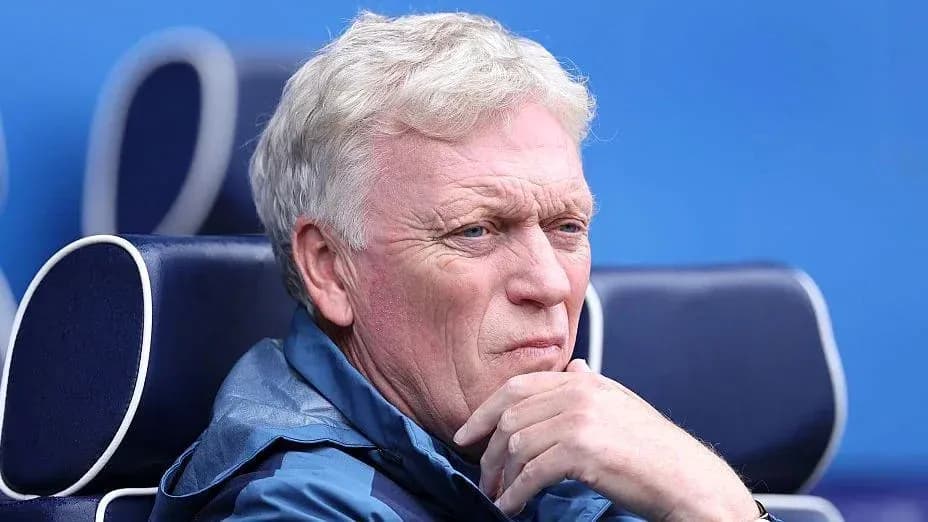 Coach sitting on bench during a match