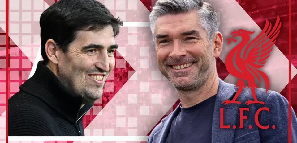 Two coaches smiling against a Liverpool background