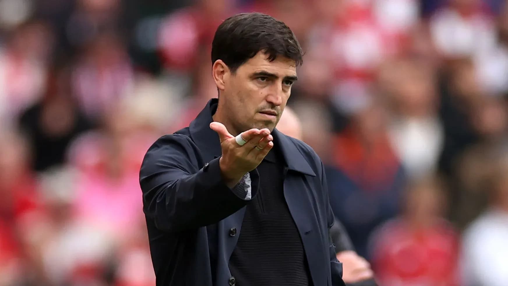 Manager gesturing during a football match