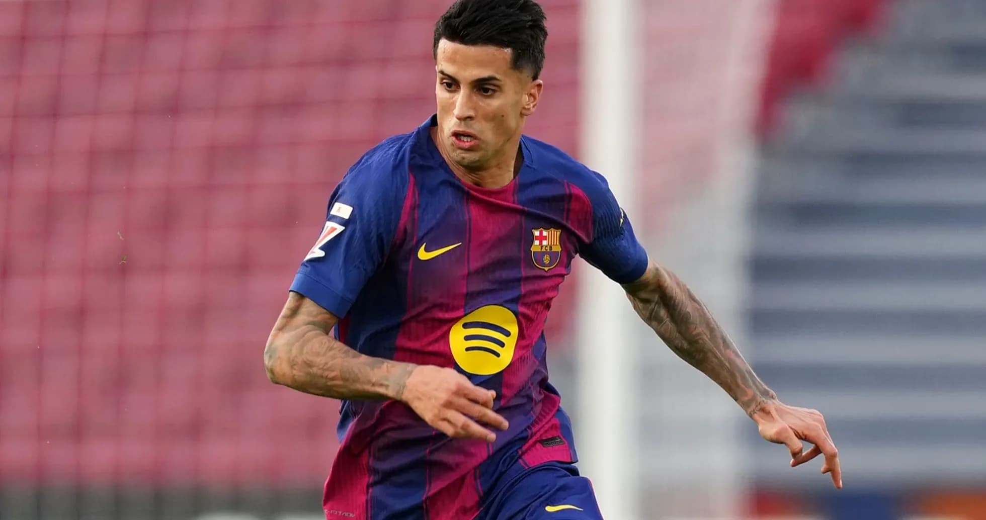Player in Barcelona jersey running on the pitch