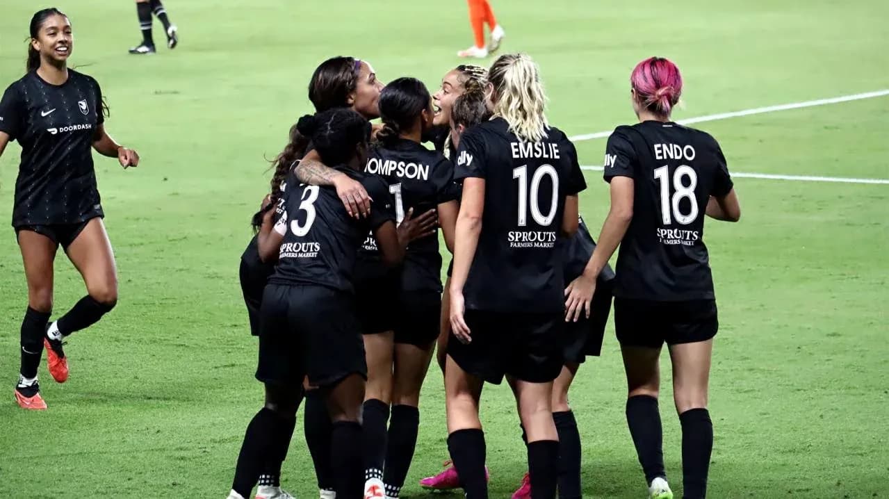 Players celebrating a goal during NWSL match