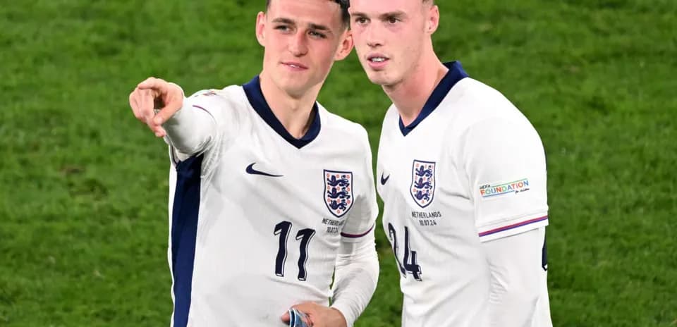 Two England players discussing on the pitch