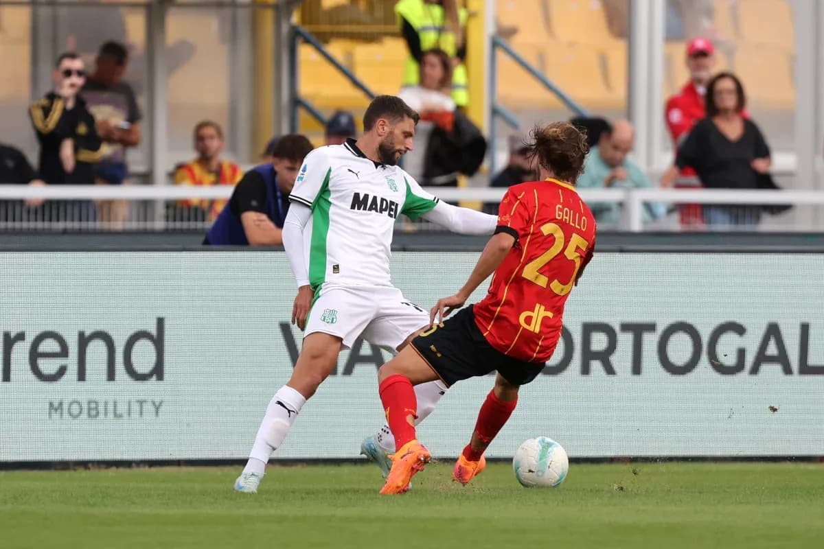 Sassuolo player tackles Lecce opponent during match
