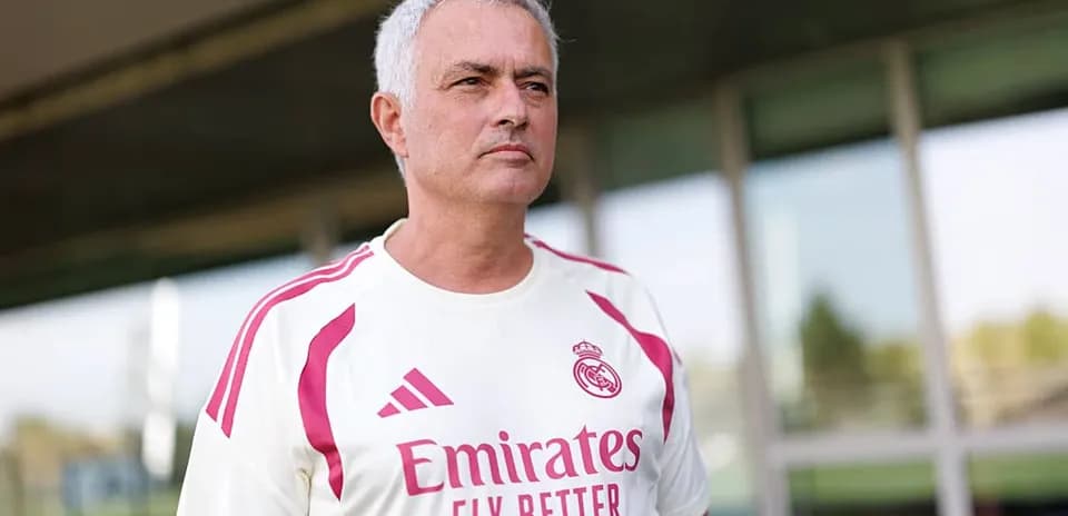 Coach wearing Real Madrid training kit outdoors