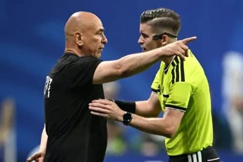 Referee discussing a decision with a coach