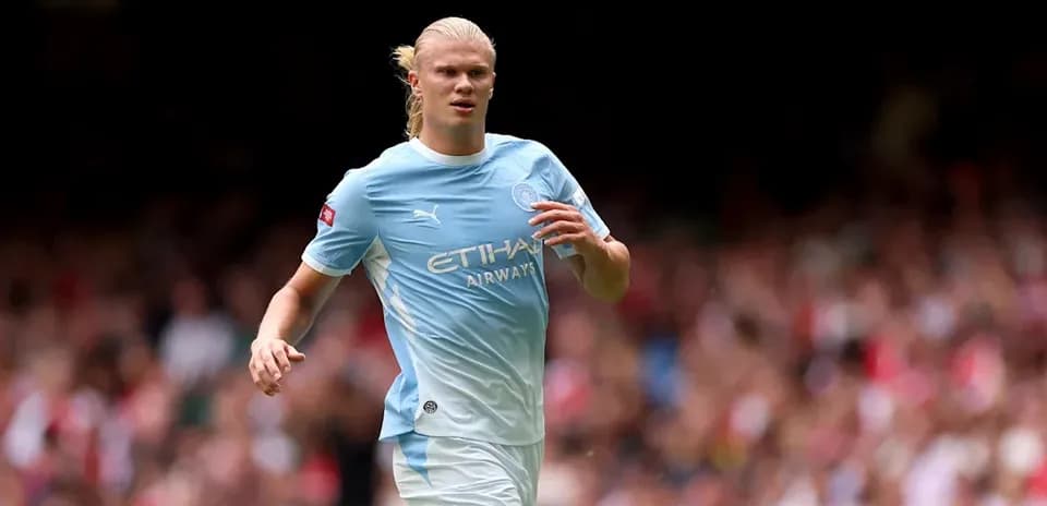 Player in light blue jersey running on the pitch