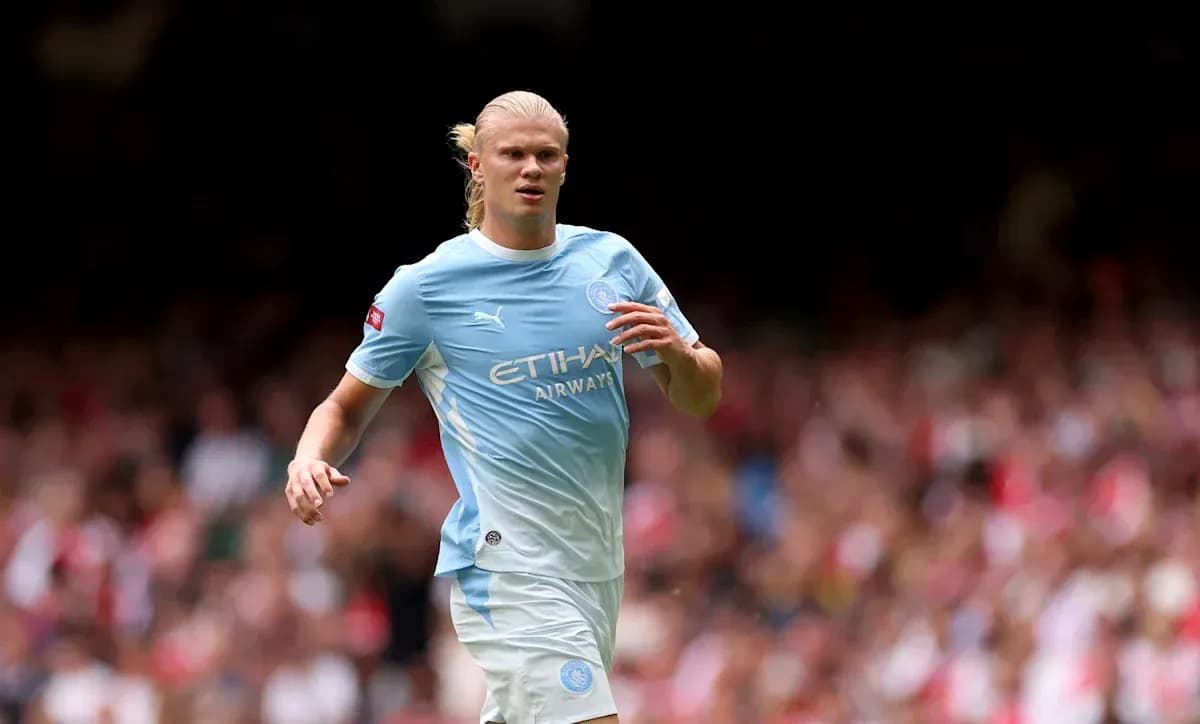 Player in light blue jersey running on the pitch