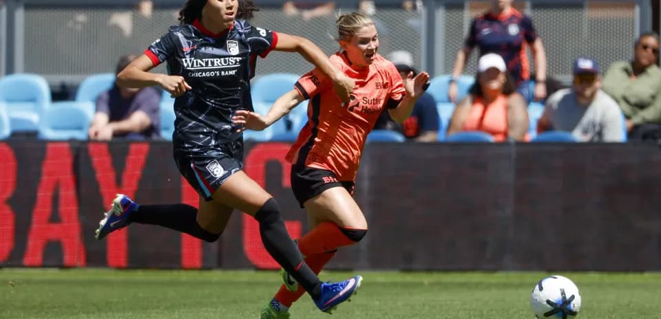 Bay FC player competing for the ball against Chicago Red Stars