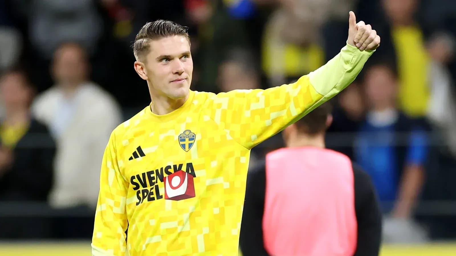 Goalkeeper in yellow kit giving thumbs up