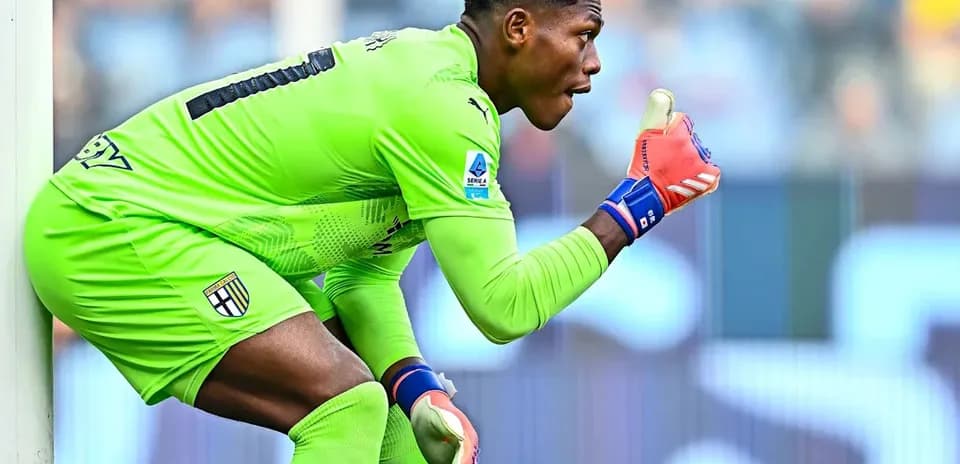 Goalkeeper in green kit signaling during match