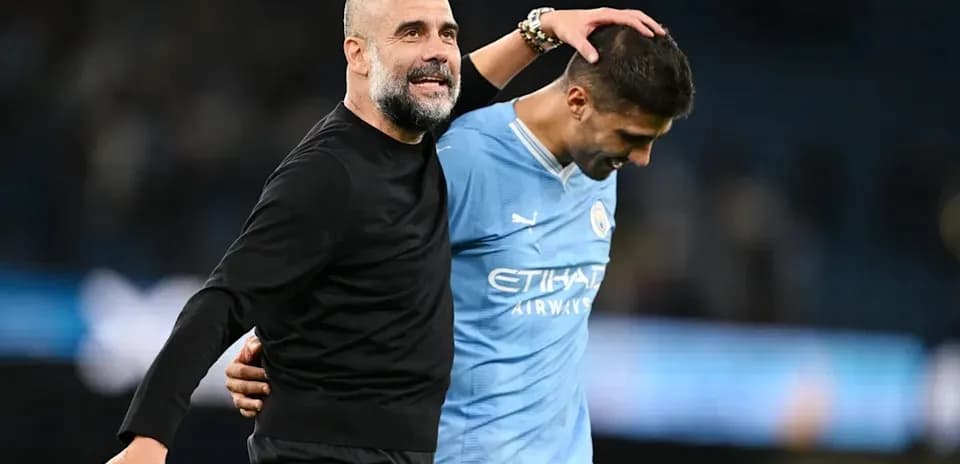 Manager and player celebrating after match conclusion