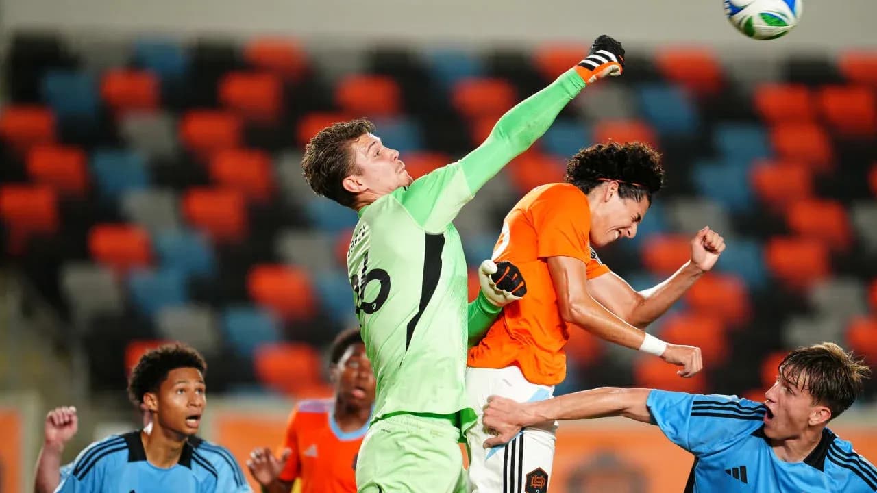 Goalkeeper punching the ball during match action