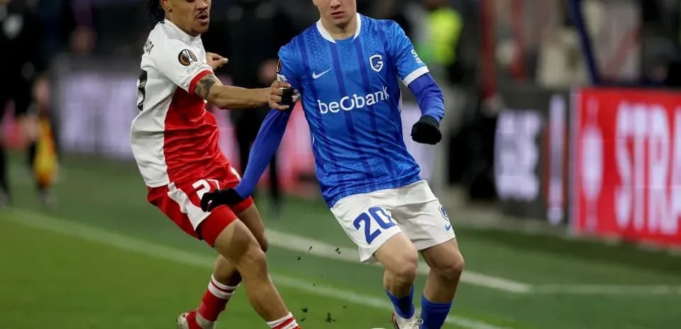 Player in blue attempting to dribble past opponent