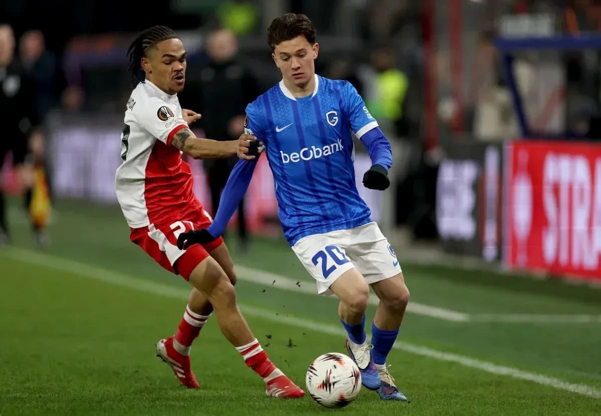 Player in blue attempting to dribble past opponent